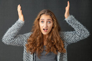 Teenage Girl with beautiful long curly hair. She looks frustrated and annoyed.