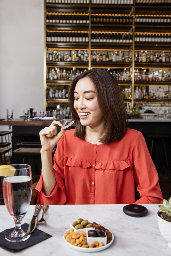 woman in cafe with Invisalign