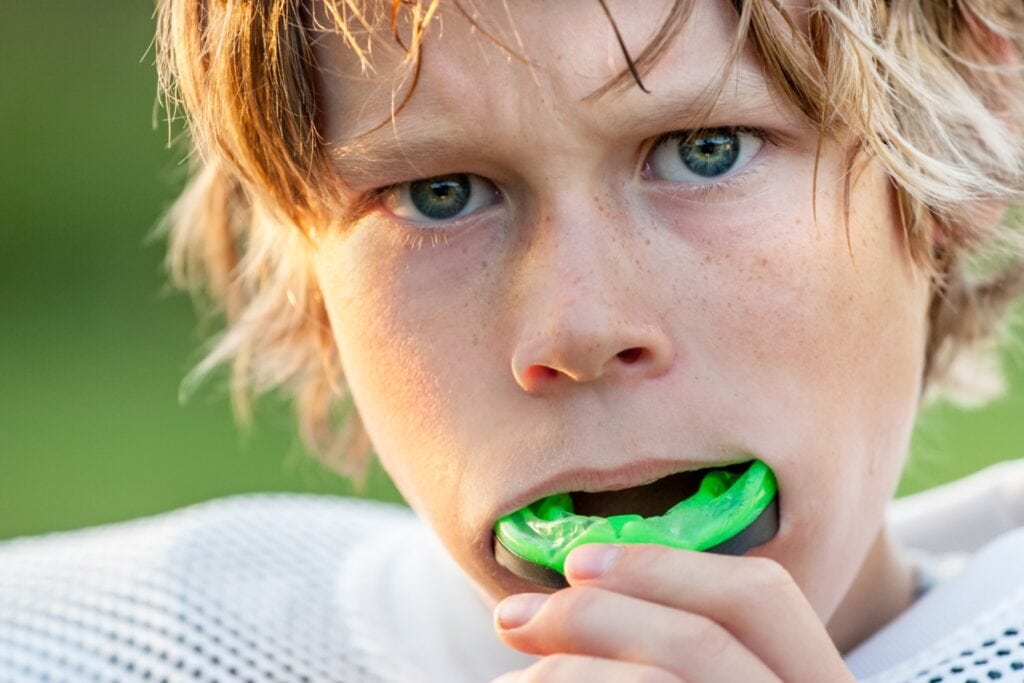 Football player using a mouthguard